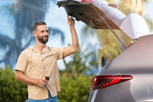 Preview: Latin man driver opening car trunk planning road trip. Transportation concept