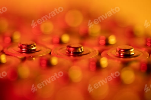 Preview: Closeup of positive ends of discharged batteries AA sizes, macro shot, selective focus. Used battery