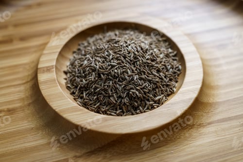Preview: Cumin seeds in a wooden plate