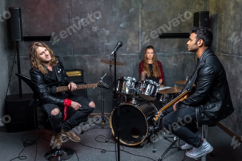 Preview: rock band resting after rehearse in studio, band on stage concept