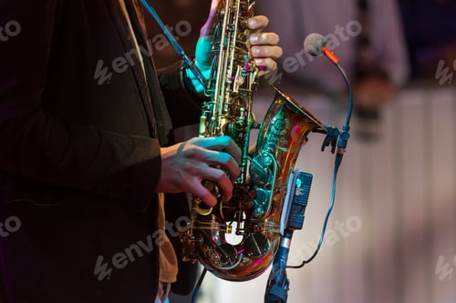 Preview: Man playing saxophone, hands with instrument in frame
