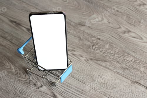 Preview: Smartphone with blank white screen inside shopping trolley