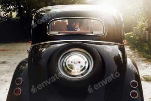 Preview: Wedding couple posing in stylish black car