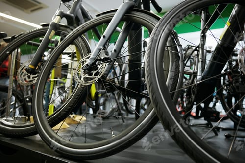 Preview: Mountain bike on rack showcase in shop closeup on bicycle wheels