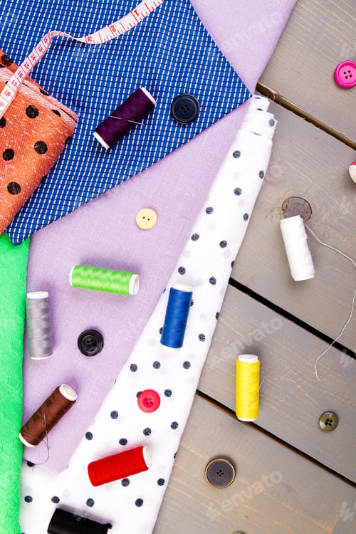 Preview: Items for sewing clothes. Sewing buttons, spools of thread and cloth. Top view.