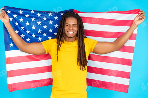 Preview: Happy latin man with dreadlocks raising north america national flag