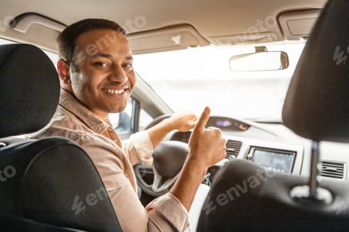 Preview: Man Smiles and Gives a Thumbs Up Driving