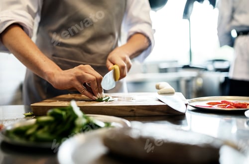 Preview: Chef cooking in restaurant kitchen