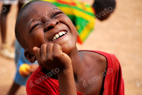Preview: African boy smiling and having fun wearing colorful clothes, acting funny in front of the camera
