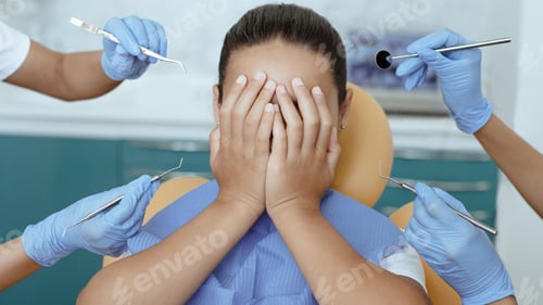 Preview: Multiracial doctors in rubber gloves scare girl with medical instruments