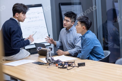 Preview: Confident Chinese designers checking a robotic arm