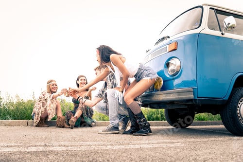 Preview: Happy friends driving a vintage minivan