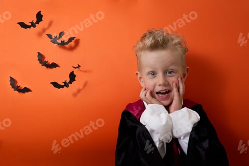 Preview: A boy in a vampire costume emotionally looks at the camera on an orange background
