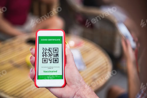 Preview: Woman holding mobile phone with covid QR code certificate in front of bar restaurant