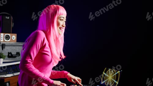 Preview: Musician with pink hair mixing and mastering techno sound