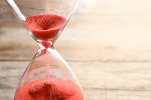 Preview: Hourglass with flowing sand on table, closeup. Time management