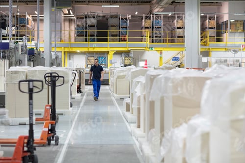 Preview: Worker walking through paper packaging factory
