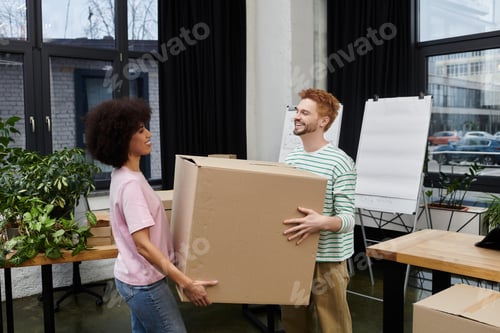 Preview: Packing and unpacking boxes during a modern moving day in a bright contemporary space