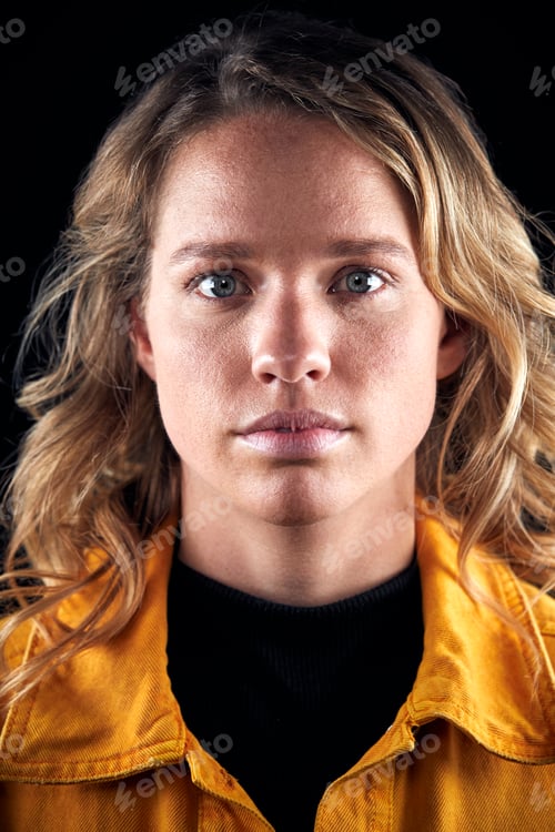 Preview: Head And Shoulders Studio Shot Of Woman Looking At Camera With Serious Expression