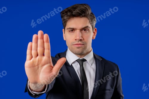 Preview: Portrait Of Serious Businessman In Professional Suit Showing Rejecting Gesture