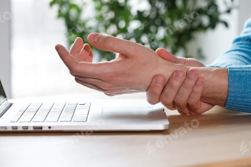 Preview: Carpal tunnel syndrome. man arms holding his painful wrist