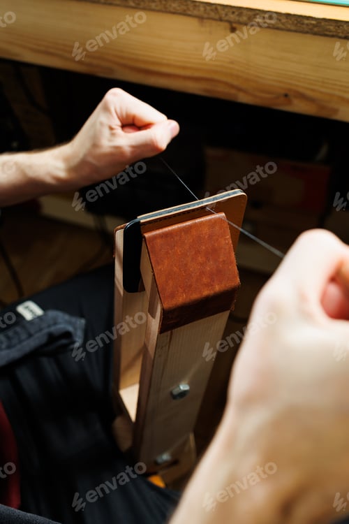 Preview: Close-up of male hands working with natural leather. Handmade products made of genuine leather.