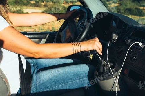 Preview: Girl driving orange van. She is wearing a beanie and steering with a large wheel.