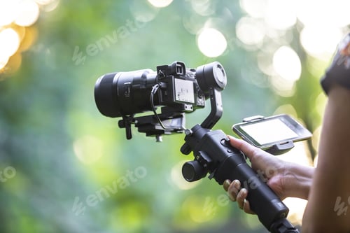 Preview: A girl operating camera mounted on a gimbal, focus on the gimbal and camera.