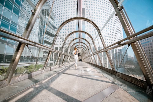 Preview: Business woman walking on the modern bridge