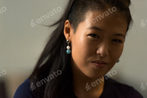 Preview: Close-up portrait of beautiful rebel Asian woman face smiling outdoors