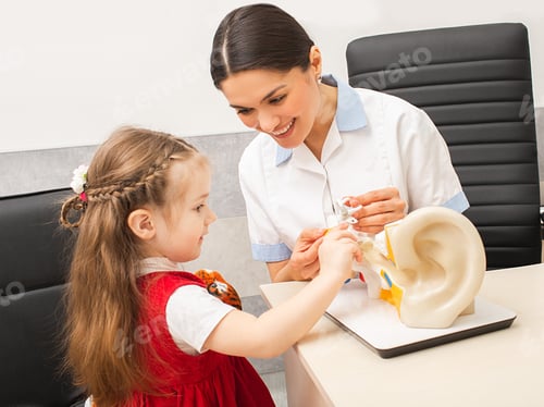 Preview: Little girl patient with pediatrician, doctor explains how the ear works. Audiologist consultation
