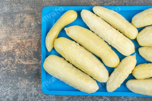 Preview: Salty delicious cucumbers on blue plate
