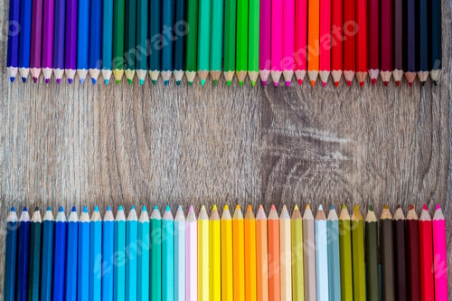 Preview: Multi Color pencils in scale with rainbow style isolated on wooden background