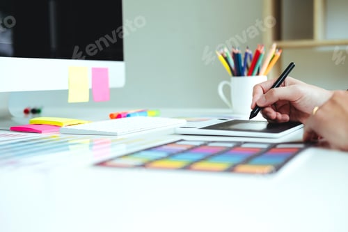 Preview: Two Graphic designer Brainstorming Meeting and drawing on graphics tablet at workplace