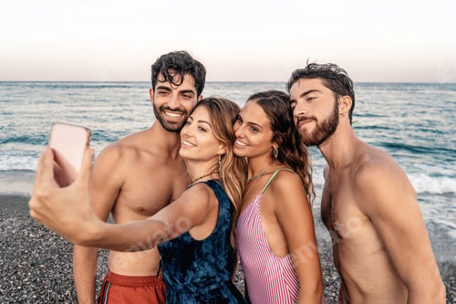 Preview: Friends taking selfies on the beach