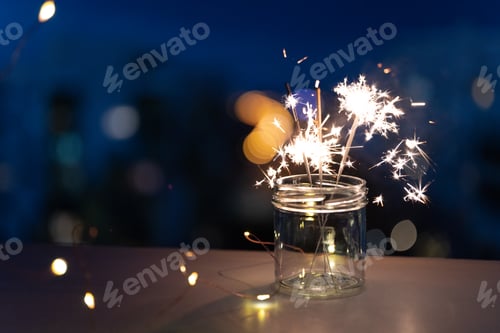 Preview: Sparklers on New Year's Eve with city background