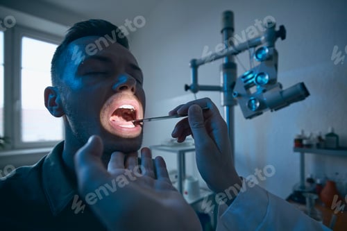 Preview: Doctor doing throat examination of young patient
