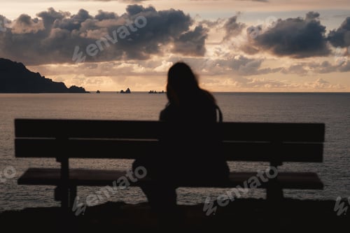 Preview: A peaceful silhouette sits on the iconic bench at Loiba Cliffs, overlooking the vast Atlantic Ocean.