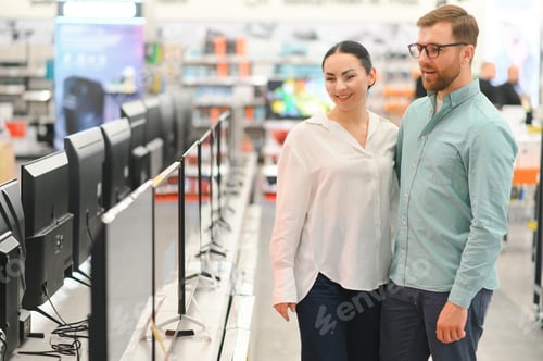 Preview: Young couple chooses plasma TV in store of household appliances