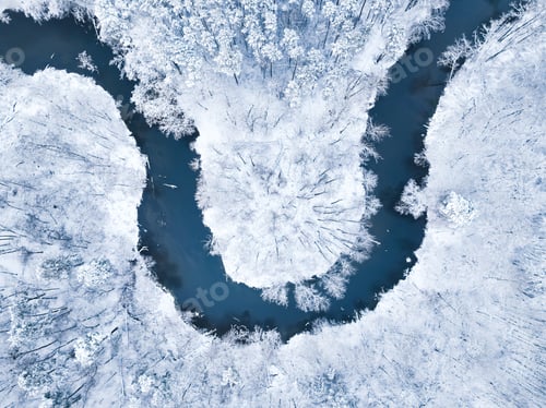 Preview: Flying above cold river and snowy forest in winter, Poland.