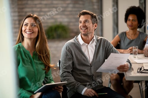 Preview: Happy business colleagues listening presentation on a meeting in the office.