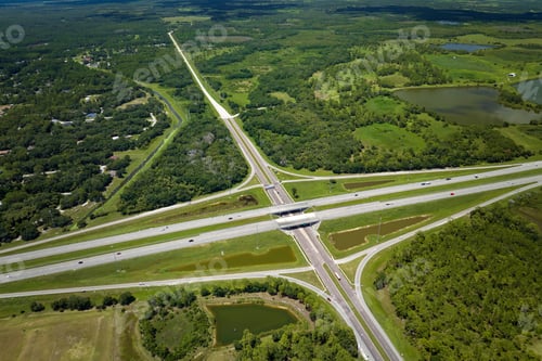 Preview: Aerial view of freeway overpass junction with fast moving traffic cars and trucks.