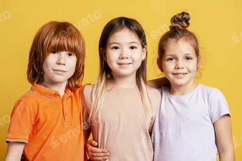 Preview: Happy diverse children standing together, smiling for a childhood friendship portrait