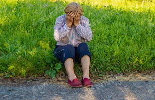 Preview: Old woman feels bad on the street, headache. Selective focus.