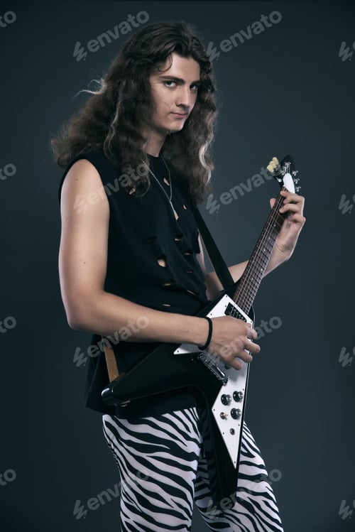 Preview: Male Hard Rock Electric Guitar Musician With Long Hair. Studio Shot Against Grey.