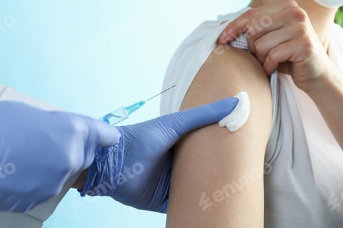 Preview: A doctor inject a woman on blue background
