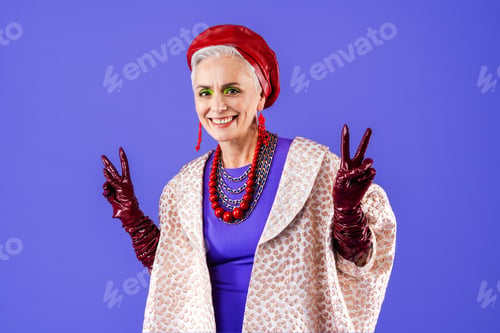 Preview: Happy and funny senior old woman on colorful background