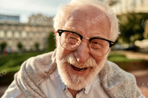 Vista previa: Don’t worry about getting older. Portrait of handsome bearded senior man in glasses looking at