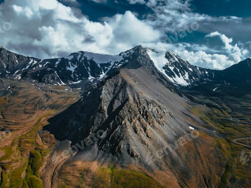 Preview: Rocky mountain ridge with snow peaks and winding valley