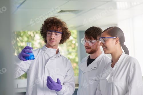 Preview: Scientist examining conical flask